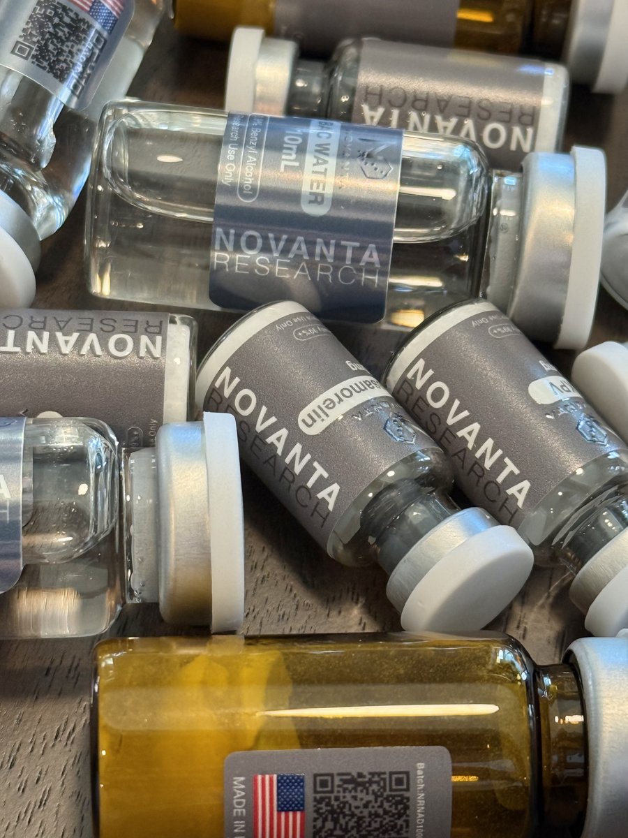 Close-up pile of Novanta Research peptide vials and Research Water